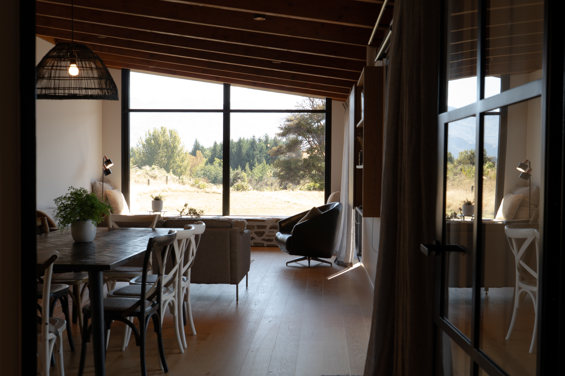Open plan living and dining with panoramic lake and mountain views